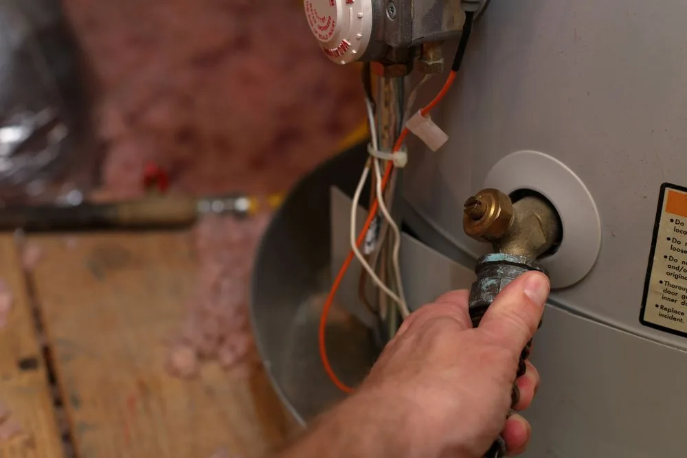 Plumber repairing a hot water system