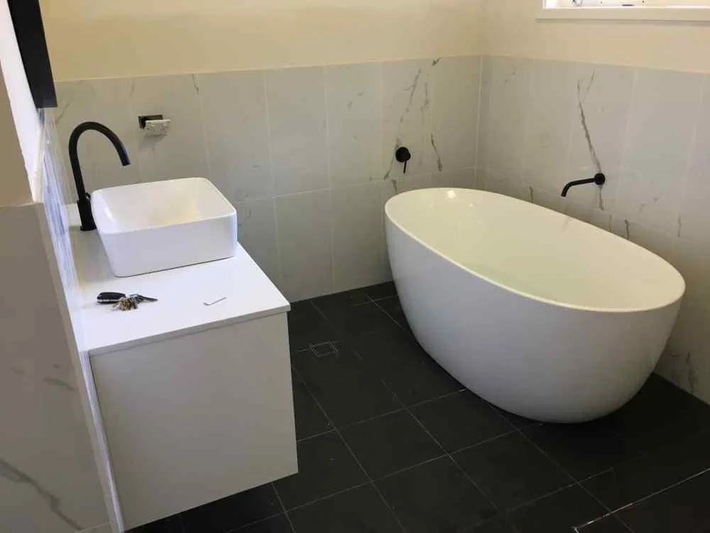 Freestanding bath and basin installed as part of a plumbing renovation on the Central Coast