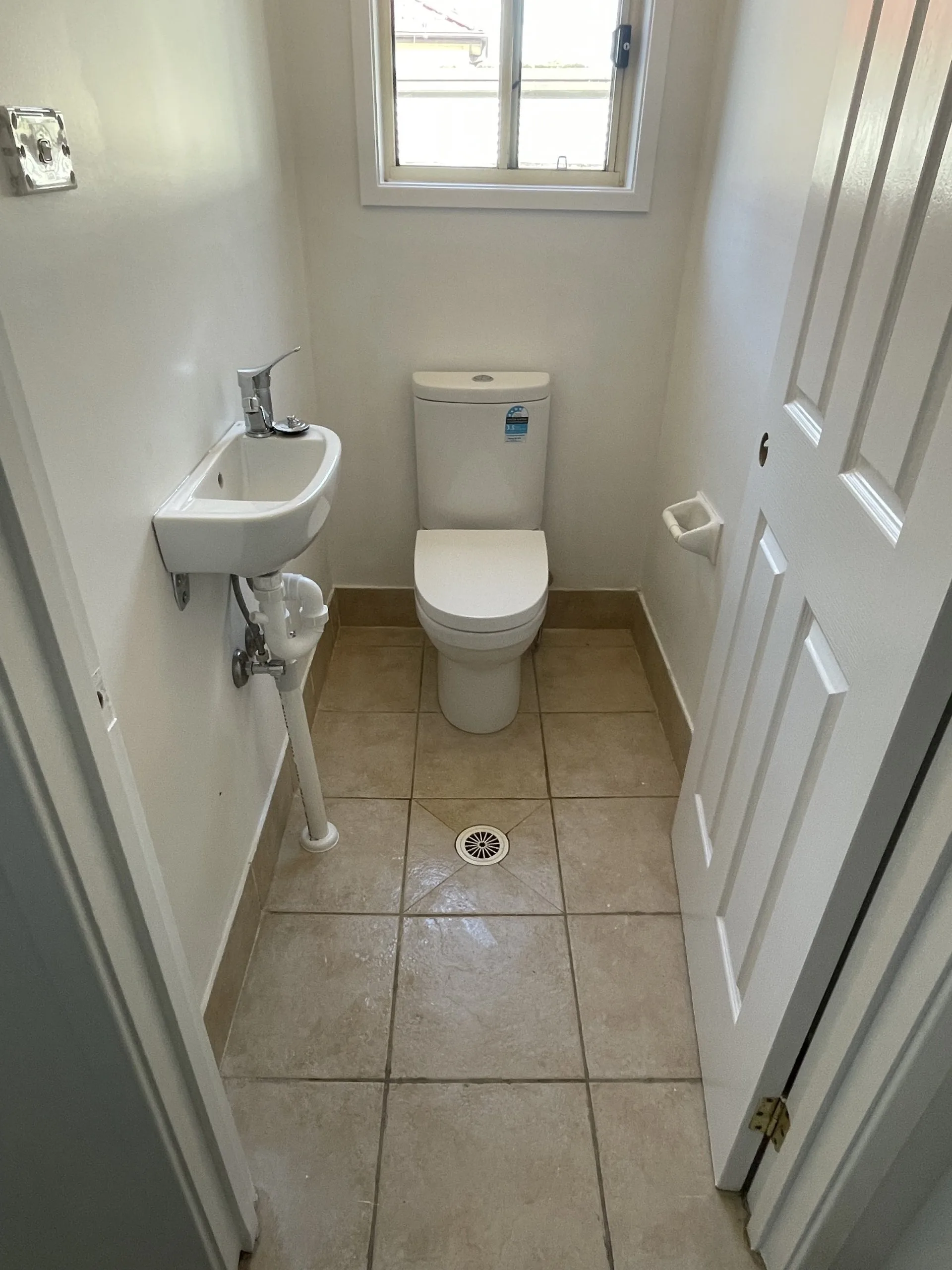 Clean bathroom with toilet and basin installed by AH Plumbing & Maintenance on the Central Coast
