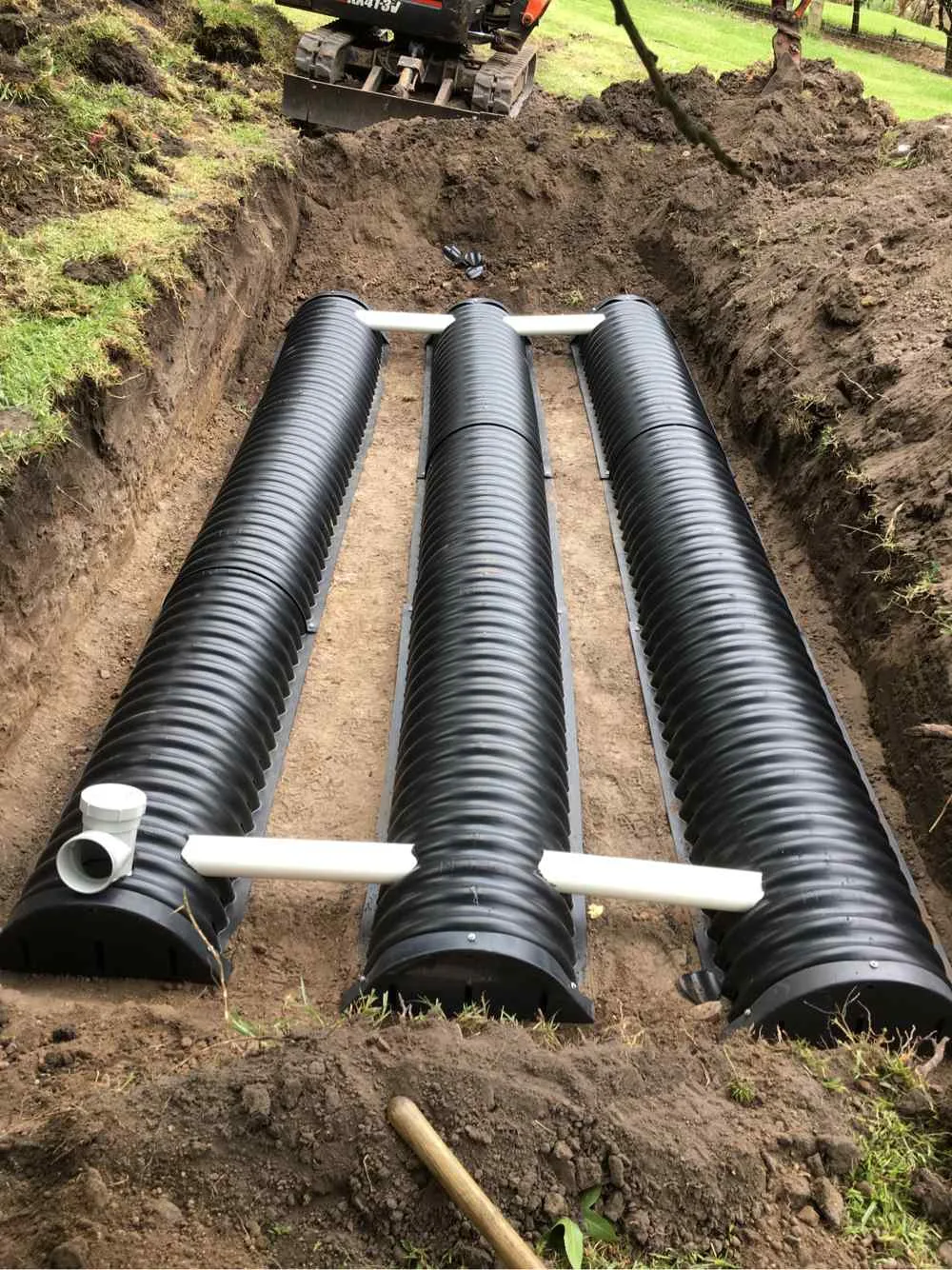 Newly installed drainage pipes laid in a deep residential trench on the Central Coast