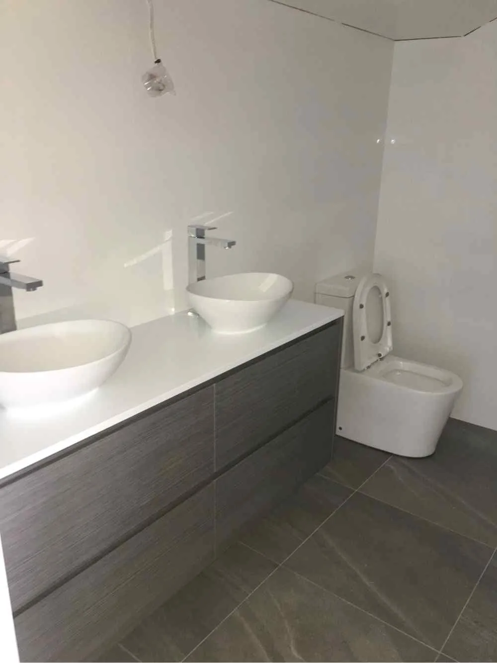 Modern double vanity bathroom renovation completed by AH Plumbing & Maintenance in Erina